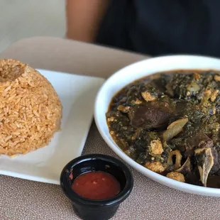 Gussi Spinach Soup with goat meat and jollof rice