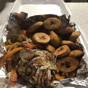 Red snapper with plantains and onions and peppers.