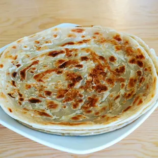 a stack of tortillas on a plate