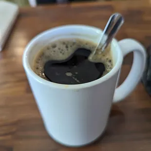 a cup of coffee with a spoon in it