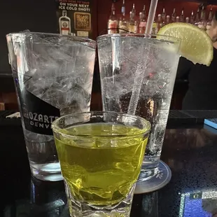 Trio of beverages - water, vodka soda, and a pickle shot