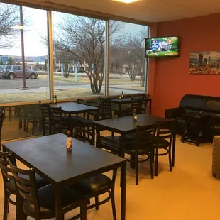 tables, chairs, couches, and a flat screen tv