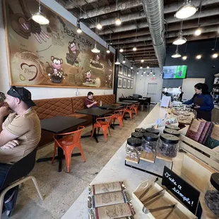 Seating near the counter and chocolates at the counter.