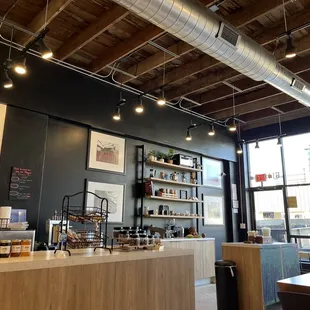 Looking toward front of store from well-padded bench with tables.