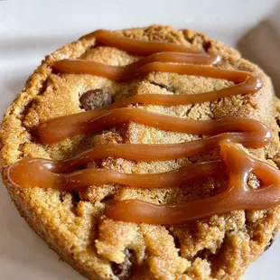a cookie with caramel drizzle on top