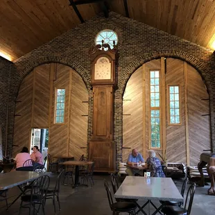 a group of people sitting at tables in a restaurant