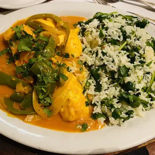 Halibut with egg, peppers (not over cooked), and white onion in sauce, served with rice and spinach.