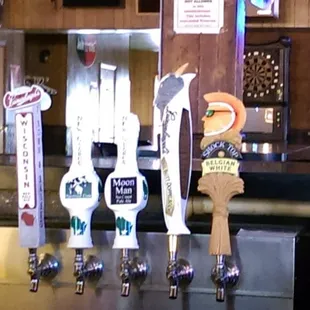 a row of beer taps in a bar