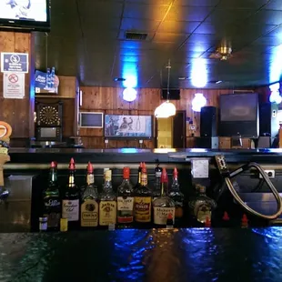 a bar with a lot of bottles of alcohol
