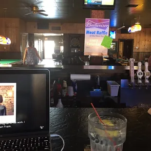 a laptop and a glass of water