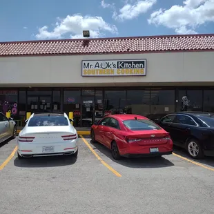 cars parked in front of a restaurant
