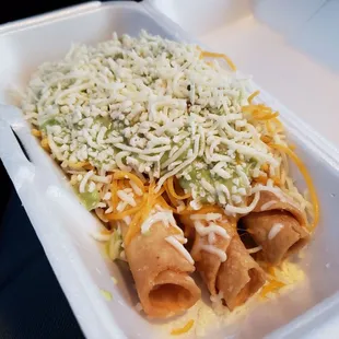 3 rolled tacos covered w/ guacamole &amp; cheese.