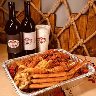 a tray of crab legs and a bottle of wine