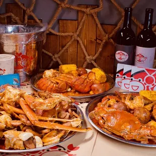 crab legs, corn, corn on the cob, and beer