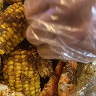 a close up of a crab and corn on the cob