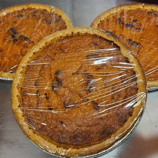 three pies wrapped in plastic