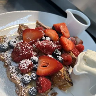 Raspberry Bread French Toast with fresh berries, pure Wisconsin maple syrup and house-made whipped cream