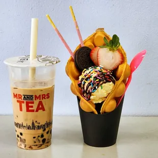 a cup of iced coffee and a strawberries and ice cream sundae