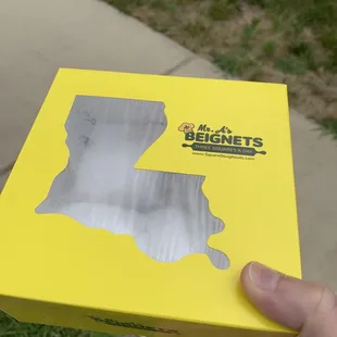 a hand holding a box