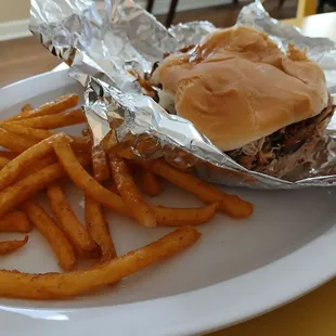 Huge pork sandwich with crispy fries