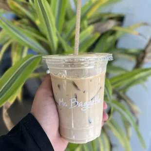  hand holding a cup of iced coffee