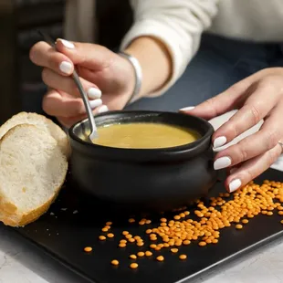  bowl of soup and a piece of bread