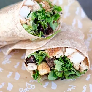 a wrap with chicken, lettuce, and croutons