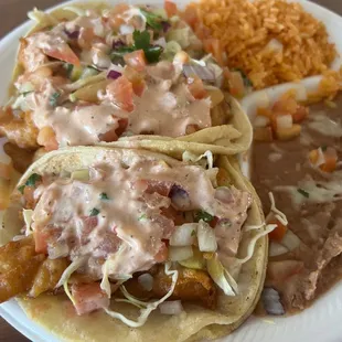 Three fish tacos with rice and beans