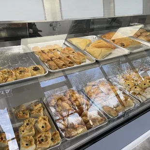 a variety of pastries in a display case