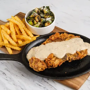 fried chicken with gravy and french fries