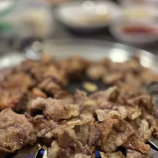 the meat being cooked on the grill