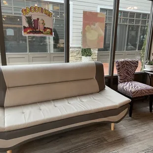a couch and chairs in a coffee shop
