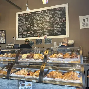 Drink menu and fresh bakery items.