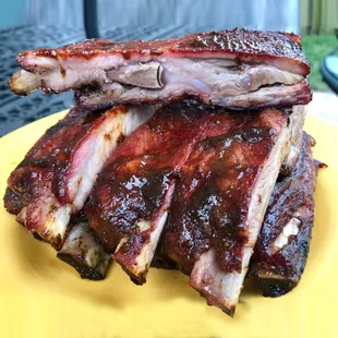 ribs stacked on a yellow plate