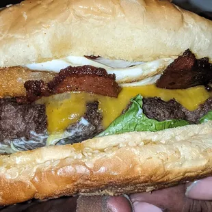 Brunch burger; medium cooked fried egg atop a hash brown over bacon and cheese coating that delicious patty.