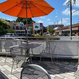 a table and chairs with an umbrella