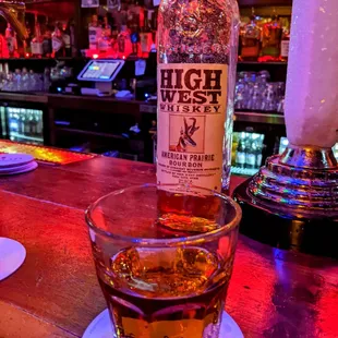 a glass of whiskey on a bar