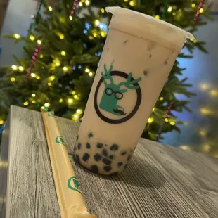a cup of milk tea and a straw