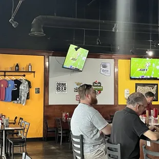 Tshirts, sit down area, and pool tables in back