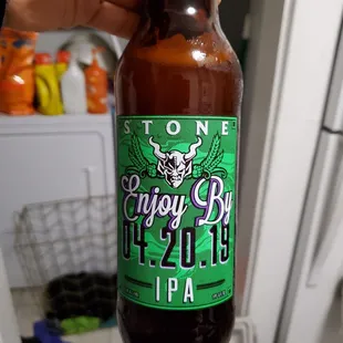 a hand holding a bottle