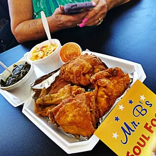 a tray of fried chicken with a side of macaroni and cheese
