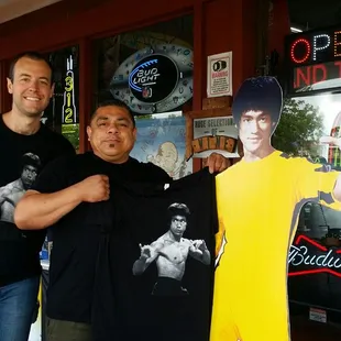 two men standing in front of a store