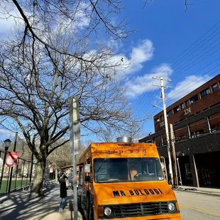 an orange truck parked on the side of the road