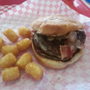 The double cowboy with tater tots has fried onions and fried jalapenos and Swiss cheese.  and they grill the bun....