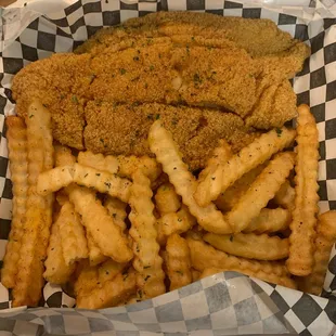 fried fish and french fries in a styrofoam container