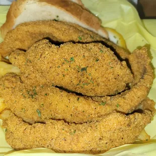 Fried catfish with crispy fries.