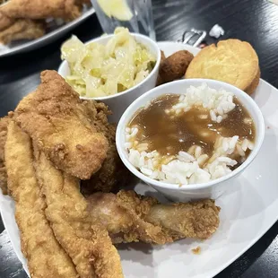 Fish and chicken with cabbage, rice and gravy and cornbread