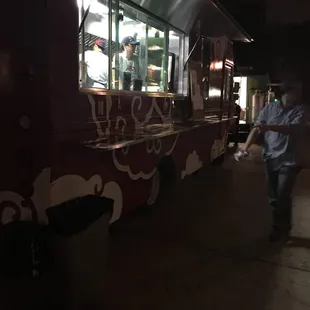 a man walking past a food truck