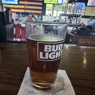 a glass of beer on a napkin