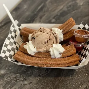 a plate of churros and ice cream